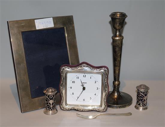 A modern silver mounted photograph frame, a silver mounted timepiece, two peppers and a candlestick, etc.